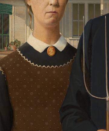 Her cameo and patterned apron sharpen the formal costume.