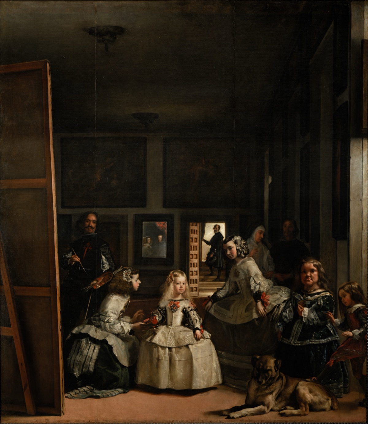Las Meninas by Diego Velázquez: a small blonde princess in a wide white dress stands in a tall, dim palace room between two bowing maids, with the painter at a huge canvas on the left, a dwarf and a large dog lying at the front right, a mirror on the back wall and a man in a bright doorway.