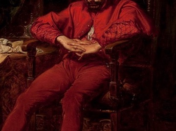 A green curtain and his red costume set his grief apart from the ball.