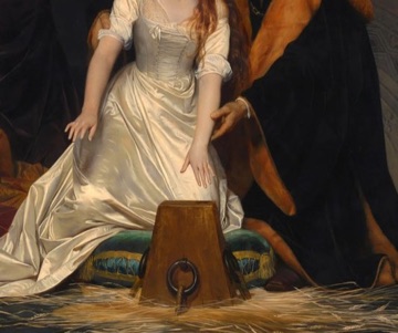 Her hands reach blindly toward the wooden block.