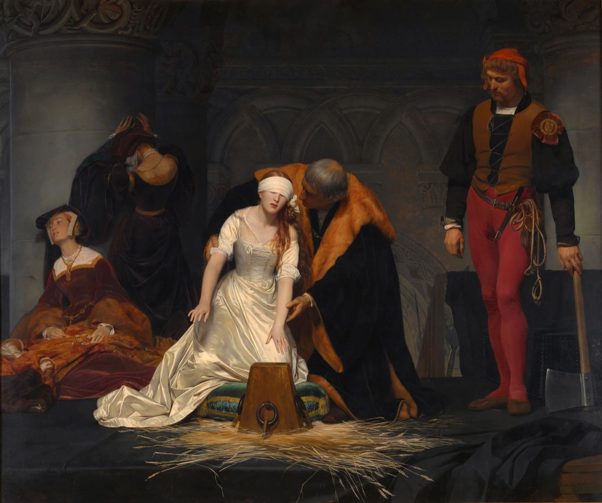 The Execution of Lady Jane Grey by Paul Delaroche: a blindfolded young woman in a white satin dress kneels and reaches for a wooden block on straw, guided by an older man, while two women grieve at left and the executioner waits at right.
